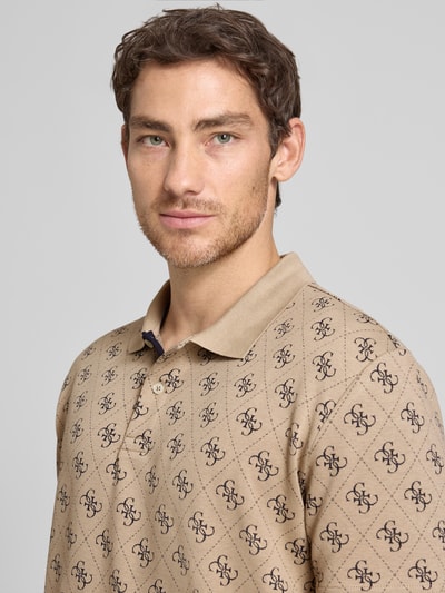 Männermodel trägt Regular Fit Poloshirt mit logomotief van guess, katoenmix met stretch, knoopsluiting, ruglengte maat M 72 cm, Nahaufnahme Oberkörper