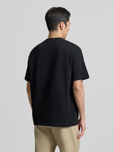 Męski model nosi Regular Fit T-Shirt aus reiner Baumwolle Modell 'Baine' von WOODBIRD, czarny kolor, krój regular fit, widok całej sylwetki z tyłu.