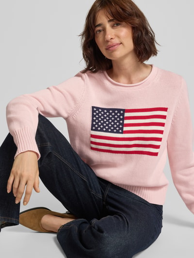 Vrouwenmodel draagt gebreide pullover met ronde hals van GAP in lichtroze, puur katoen, regular fit, ribboorden, ruglengte maat S 53 cm, mouwlengte maat S 64 cm, detailopname bovenlichaam.