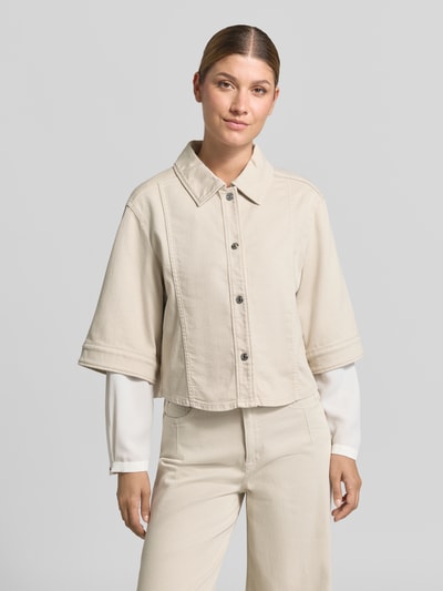 Frauenmodel trägt Relaxed Fit Blazer aus Baumwoll-Mix in Denim-Optik von Marc Cain in Beige, Umlegekragen, 1/2-Arm, Ganzkörperansicht von vorne.