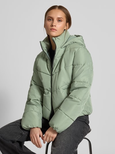Vrouwenmodel draagt mintgroen gewatteerd jack met capuchon Regular Fit Steppjacke mit Kapuze model 'CLAIR' van ONLY, Dames Steppjacke, halfclose-up bovenlichaam.