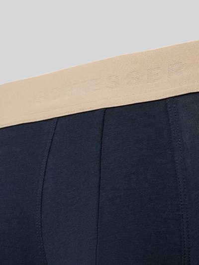 Produktfoto, Trunks aus Baumwoll-Mix im 5er-Pack von SCHIESSER, dunkelblau mit beigem elastischem Logo-Bund, eng anliegende Passform