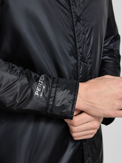 Męski model nosi Oversized Kurtka z wykładanym kołnierzem Model 'EVINUZ' od HUGO, efekt: jednolity kolor, długi rękaw, wpuszczane kieszenie, wyhaftowane logo, zapięcie na guziki, detal z bliska, ujęcie: zbliżenie na rękaw.