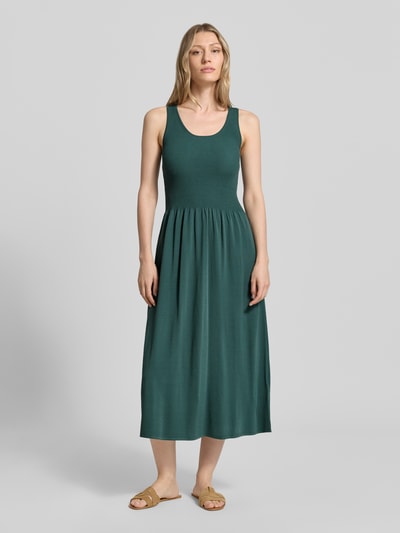 Vrouwenmodel draagt groene A-lijn tricotjurk uit viscosemix model 'CALIBRI' van Weekend Max Mara, dames tricotjurk, vooraanzicht volledige lengte