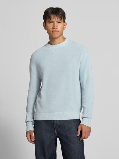 Männermodel trägt Regular Fit Strickpullover aus reiner Baumwolle von REVIEW in Hellblau, feine Struktur, Rundhalsausschnitt, Ganzkörperansicht von vorne.