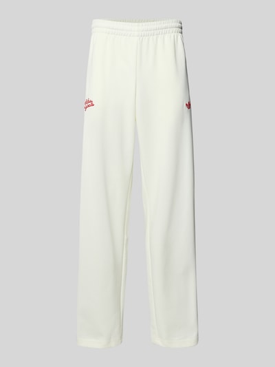 Produktfoto, Sweatpants mit Reißverschlusstaschen und Logo-Stitching von adidas Originals in Offwhite, lockerer Schnitt, Baumwoll-Anteil, seitliche Reißverschlusstaschen, Logo-Stitching.