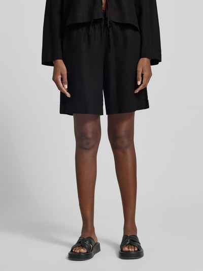 Frauenmodel trägt Leinenshorts mit elastischem Bund Modell 'Lava' von FREE/QUENT, schwarzer Leinenmix, Loose Fit, Nahaufnahme Oberschenkel.