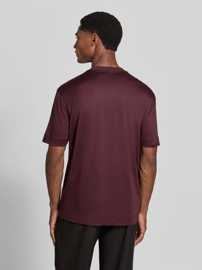 Männermodel trägt T-Shirt mit Label-Print von Emporio Armani, dunkelrot, Lyocell-Baumwoll-Mix, gerader Schnitt, Ganzkörperansicht Rückansicht.