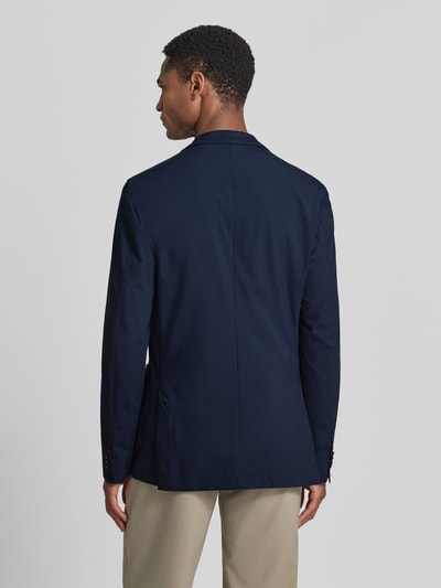 Männermodel trägt Slim Fit Anzugsakko mit Reverskragen Modell 'P-HANRY-J-WG-233' von BOSS, Optik: Unifarben, Ganzkörperansicht Rückansicht.