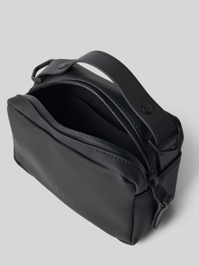 Produktfoto, czarna Handtasche mit Reißverschluss Modell 'BOX BAG MICRO' von RAINS, matowa faktura, Szerokość w rozmiarze 1: 17 cm, długość 12 cm, głębokość 8 cm, pasek regulowany 87 cm, detal z logo, główna komora zamykana na zamek