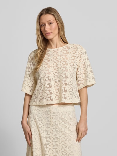 Frauenmodel trägt Semitransparentes Blusenshirt mit Rundhalsausschnitt von Jake*s Collection, Baumwoll-Mix, Boxy-Fit, cremefarben mit floraler Struktur, Semitransparenz, Rückenlänge 47 cm, Ärmellänge 29 cm, Ganzkörperansicht von vorne.