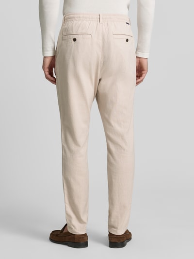 Mężczyznamodel nosi Regular Fit Chino aus Baumwoll-Mix od Tom Tailor, kolor melanż, boczne kieszenie, bawełna mieszanka, widok całej sylwetki z tyłu.