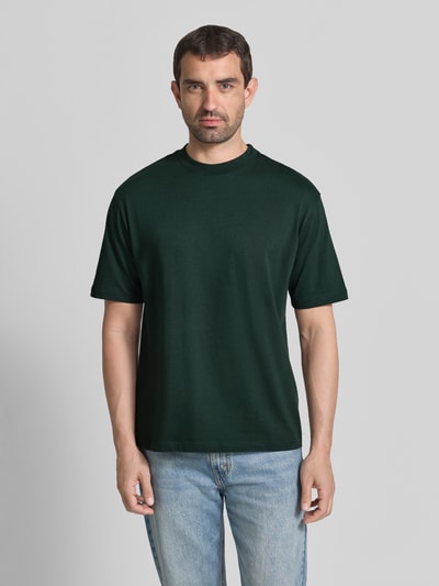 Männermodel trägt Regular Fit T-Shirt mit Rundhalsausschnitt von MCNEAL in Dunkelgrün, reine Baumwolle, kurzärmelig, Ganzkörperansicht von vorne.