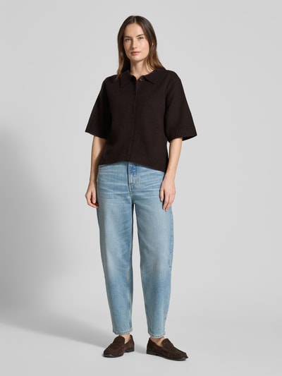 Frauenmodel trägt Regular Fit Hemdbluse mit Woll-Anteil Modell 'Cunna' von Neo Noir, dunkler Ton, Strick-Optik, Halbarm, Ganzkörperansicht von vorne.