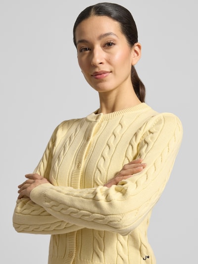 Vrouwenmodel draagt Strickjacke mit Zopfmuster und Rundhalsausschnitt van JAKE*S STUDIO WOMAN, puur katoen, slim fit, kabelpatroon, knoopsluiting. Nahaufnahme bovenlichaam.