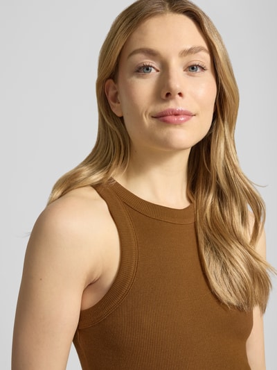 Modelka kobieca nosi brązowy Tanktop mit Rundhalsausschnitt Modell 'CYNDA' od Bash, czysta bawełna, krój slim fit, prążkowana struktura, zbliżenie na górną część ciała