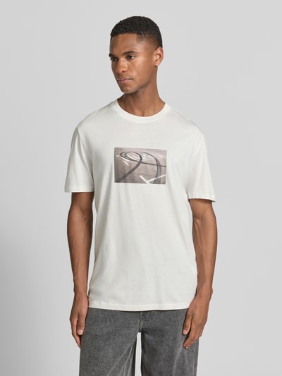 Männermodel trägt Herren T-Shirt von HUGO, Modell 'DOSTINO', Optik: Unifarben, Passform: Relaxed-Fit, Label-Print, Rundhals-Ausschnitt, Ärmelform: Kurzarm, Materialverarbeitung: Jersey, Reine Baumwolle, Ganzkörperansicht von vorne.