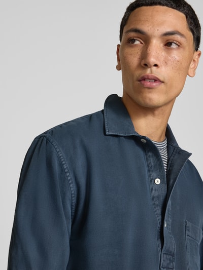 Mannelijk model draagt Regular Fit Poloshirt met Polokraag van Officine Générale, puur katoen, borstzak, shirt met lange mouwen, ruglengte maat M: 73 cm, detailopname bovenlichaam.