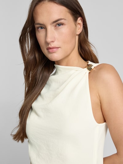 Frauenmodel trägt Blusentop in asymmetrischem Design Modell 'JOIA' von Mango in Creme, taillierte Passform, Nahaufnahme Oberkörper.