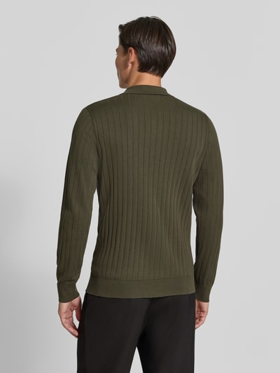 Männermodel trägt Regular Fit Poloshirt aus reiner Baumwolle Modell 'TORINO' von Selected in Olivgrün mit feiner Rippstruktur, Ganzkörperansicht Rückansicht.