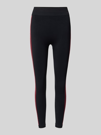 Produktfoto, Leggings mit Galonstreifen Modell 'SEAMLESS' von Tommy Hilfiger in Schwarz mit roten Seitenstreifen, eng anliegend, elastischer Bund, glatte Textur, Material-Mix mit Stretch-Anteil, dezente Label-Details.