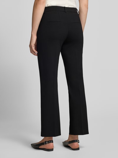 Männermodel trägt czarne spodnie z szerokimi nogawkami Wide Leg Hose mit Gürtelschlaufen Modell 'Fenja' od Stehmann, widok całej sylwetki od tyłu