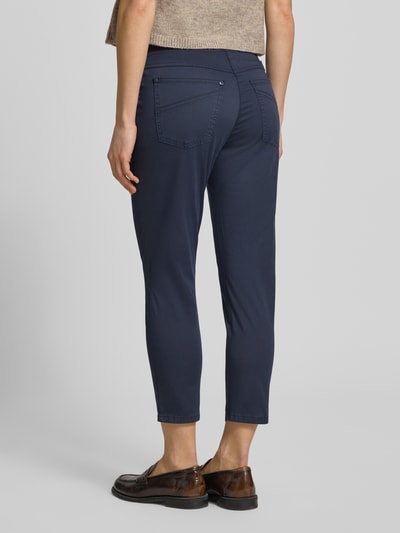 Kobieta nosi Caprihose mit elastischem Bund Modell 'Pamina' od Raphaela By Brax, bawełna z elastanem, krój regular fit, szerokość w rozmiarze 36K: 35 cm, długość wewnętrzna nogawki w rozmiarze 36K: 62 cm, granatowy kolor, gładka tekstura, widok całej sylwetki z tyłu.