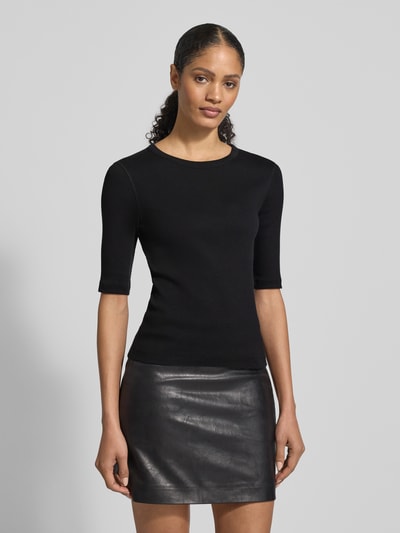Modelka nosi Regular Fit Longsleeve mit Rundhalsausschnitt Modell 'Selay' od Drykorn, czarna bawełna, wzór strukturalny, półrękaw, widok całej sylwetki z przodu.