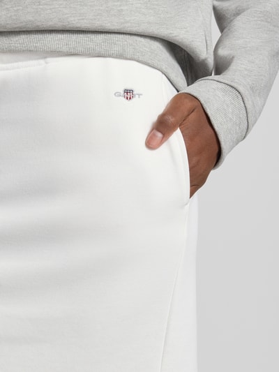 Vrouwenmodel draagt Sweatrock met Label-Stitching van Gant, witte katoenmengsel, recht model, elastische tailleband met tunnelkoord, detailopname rechterzij.
