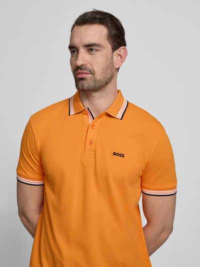 Männermodel trägt Regular Fit Poloshirt aus reiner Baumwolle Modell 'PADDY' von BOSS Green, Optik: Unifarben, Nahaufnahme Oberkörper.