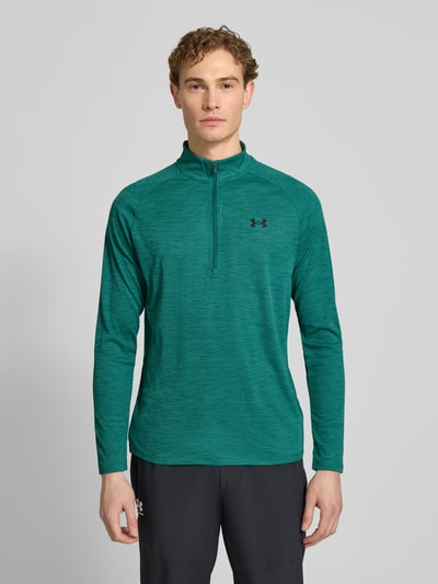 Mannelijk model draagt Sweatshirt mit kurzem Reißverschluss und Logo-Print van Under Armour in groen, recht model, opstaande kraag, logoprint, ruglengte maat M 74 cm, mouwlengte maat M 64 cm, geheel van voren bekeken, ganzkörperansicht von vorne.