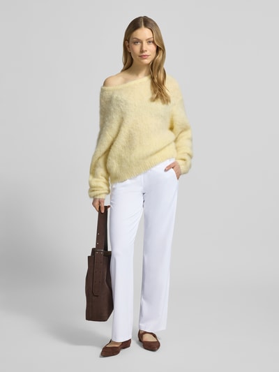Frauenmodel trägt Straight Leg Jogpants aus Hightech Jersey Modell 'CANDICE' von Raffaello Rossi in Weiß, mit elastischem Bund und Schnürung, kombiniert mit hellgelbem Pullover und braunen Accessoires, Ganzkörperansicht von vorne.