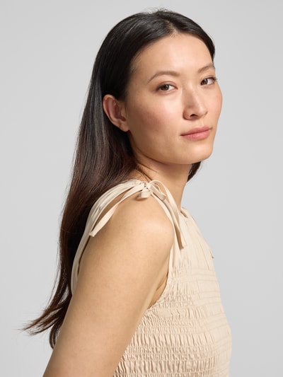 Frauenmodel trägt Midikleid mit Smok-Detail von Comma, Beige, Baumwoll-Mix, Rundhalsausschnitt, Ärmelloses-Design, Nahaufnahme Oberkörper. Rückenlänge bei Größe 36: 128 cm, Brustweite bei Größe 36: 36 cm, Taillierte Passform.