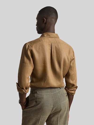 Mannermodel draagt Regular Fit Freizeithemd aus reinem Leinen van Polo Ralph Lauren in effen lichtbruin, enkelvoudige knopenrij en rugpas met plooi, casual fit, flammengaren, detailopname rugaanzicht.