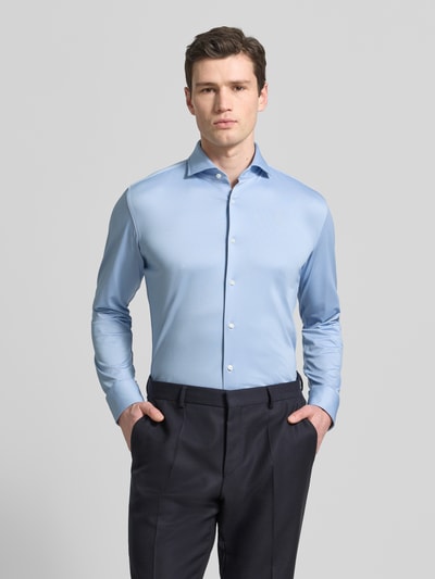 Männermodel trägt Slim Fit Businesshemd aus atmungsaktivem Material Modell 'P-HANK-SPREAD' von BOSS in Hellblau, Ganzkörperansicht von vorne.