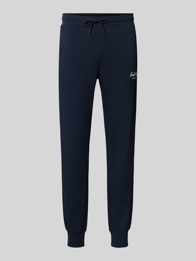 Produktfoto, Sweatpants mit Label-Print Modell 'GORDON' von JACK & JONES in Dunkelblau, lockere Passform, weiche Textur, elastischer Bund.
