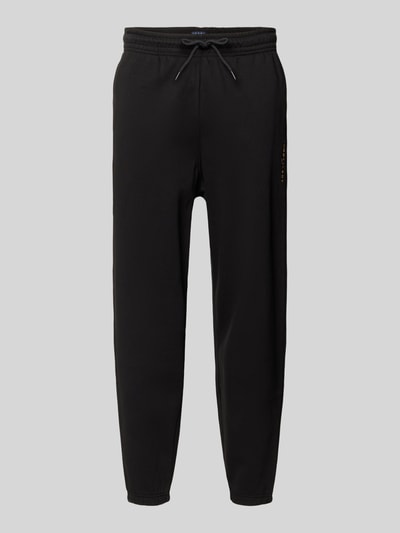 Produktfoto, Regular Fit Sweatpants aus Baumwoll-Mix von Tommy Jeans in Optik: Unifarben mit elastischem Bundabschluss, Label-Stitching-Applikation, Tunnelzug-Verschluss, seitlichen Eingrifftaschen, Gesäßtasche und Sweat-Materialverarbeitung.
