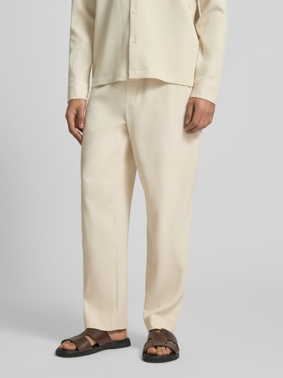 Männermodel trägt Hose mit elastischem Bund in Plissee-Optik von REVIEW, Beige, Material-Mix mit Stretch-Anteil, Regular-Fit, Nahaufnahme Unterkörper.