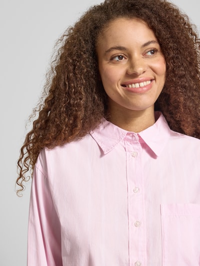 Frauenmodel trägt Regular Fit Bluse mit Brusttasche von Gina Tricot aus Reine Baumwolle, Hemdblusenkragen, Knopfleiste, Nahaufnahme Oberkörper.