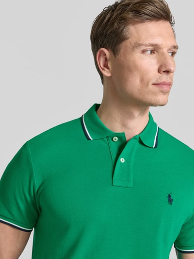 Männermodel trägt Slim Fit Poloshirt aus reiner Baumwolle von Polo Ralph Lauren, Optik: Unifarben, Kontraststreifen, Nahaufnahme Oberkörper.