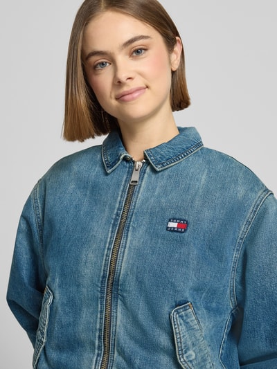 Frauenmodel trägt Regular Fit Jeansjacke aus reiner Baumwolle von Tommy Jeans, Optik: Unifarben, Denim, Nahaufnahme Oberkörper.