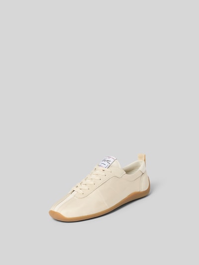 Produktfoto, Sneaker mit Ziernähten von Kenzo in Beige mit abgerundeter Form, Schnürverschluss, Satin und strukturierter Sohle vor grauem Hintergrund.