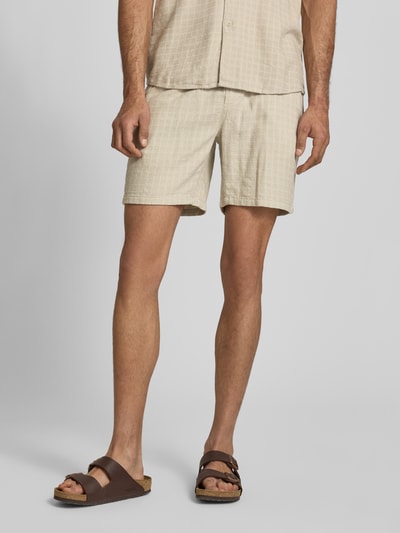 Männermodel trägt Regular Fit Shorts aus Viskose-Leinen-Mix Modell 'TEL LATHAM' von Only & Sons, Optik: Unifarben, Struktur-Muster, Tunnelzug, Bundabschluss: Elastisch, seitliche Eingrifftaschen, Materialverarbeitung: Flammgarn, Ganzkörperansicht von vorne.
