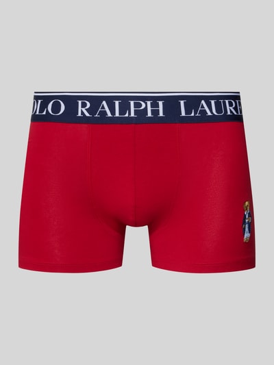 Produktfoto, Trunks aus Baumwoll-Mix mit Polo Bear von Polo Ralph Lauren Underwear, Optik: Unifarben, Applikation: Polo Bear, Label-Bund, Bundabschluss: elastisch, Material: Baumwoll-Mix, rote Grundfarbe mit dunkelblauem Bund und kontrastierendem Polo Bear-Motiv, glatte Textur.