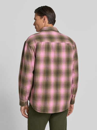 Männermodel trägt Regular Fit Freizeithemd aus Baumwolle Modell 'Carter' von Wood Wood in Rosa und Oliv mit Karomuster, Ganzkörperansicht Rückansicht. Reine Baumwolle, Kentkragen, Knopfleiste, Brusttasche, langärmliges Design.