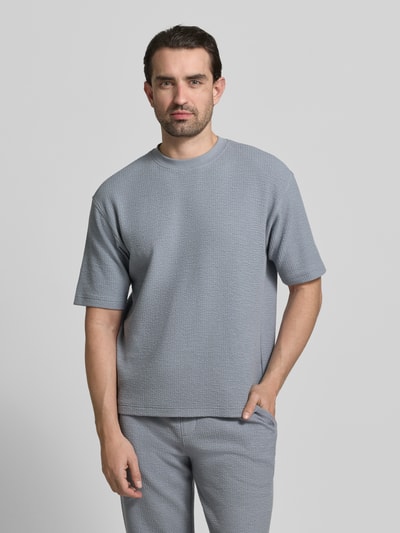 Männermodel trägt Relaxed Fit T-Shirt mit Rundhalsausschnitt von JAKE*S STUDIO MEN im Modal-Baumwoll-Mix mit Strukturmuster, Ganzkörperansicht von vorne.