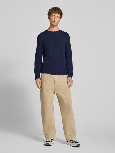 Männermodel trägt navyblauen Slim Fit Pullover aus reiner Baumwolle von REVIEW, Strick-Optik, Rundhalsausschnitt, Ganzkörperansicht von vorne.
