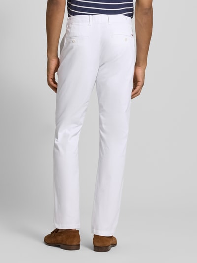 Männermodel trägt Slim Fit Chino aus Baumwoll-Mix von Tommy Hilfiger, Optik: Unifarben, Passform: Slim-Fit, Gesäßtaschen mit Knopf, Ganzkörperansicht Rückansicht.