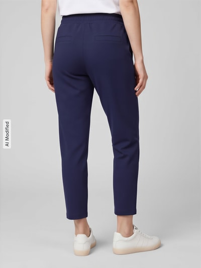 Frauenmodel trägt Sweatpants mit Paspeltaschen am Gesäß von Christian Berg Woman, dunkelblau, lockerer Schnitt, Rückansicht, KI-modifiziertes Bild.