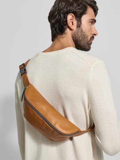 Männermodel draagt Bauchtasche aus echtem Leder Modell 'HYDE PARK' van Strellson, look: effen, glad leer, ritsvak, label in reliëf, hoofdfak, draagoptie: heupgordel, kleur bruin. Ganzkörperansicht Rückansicht.